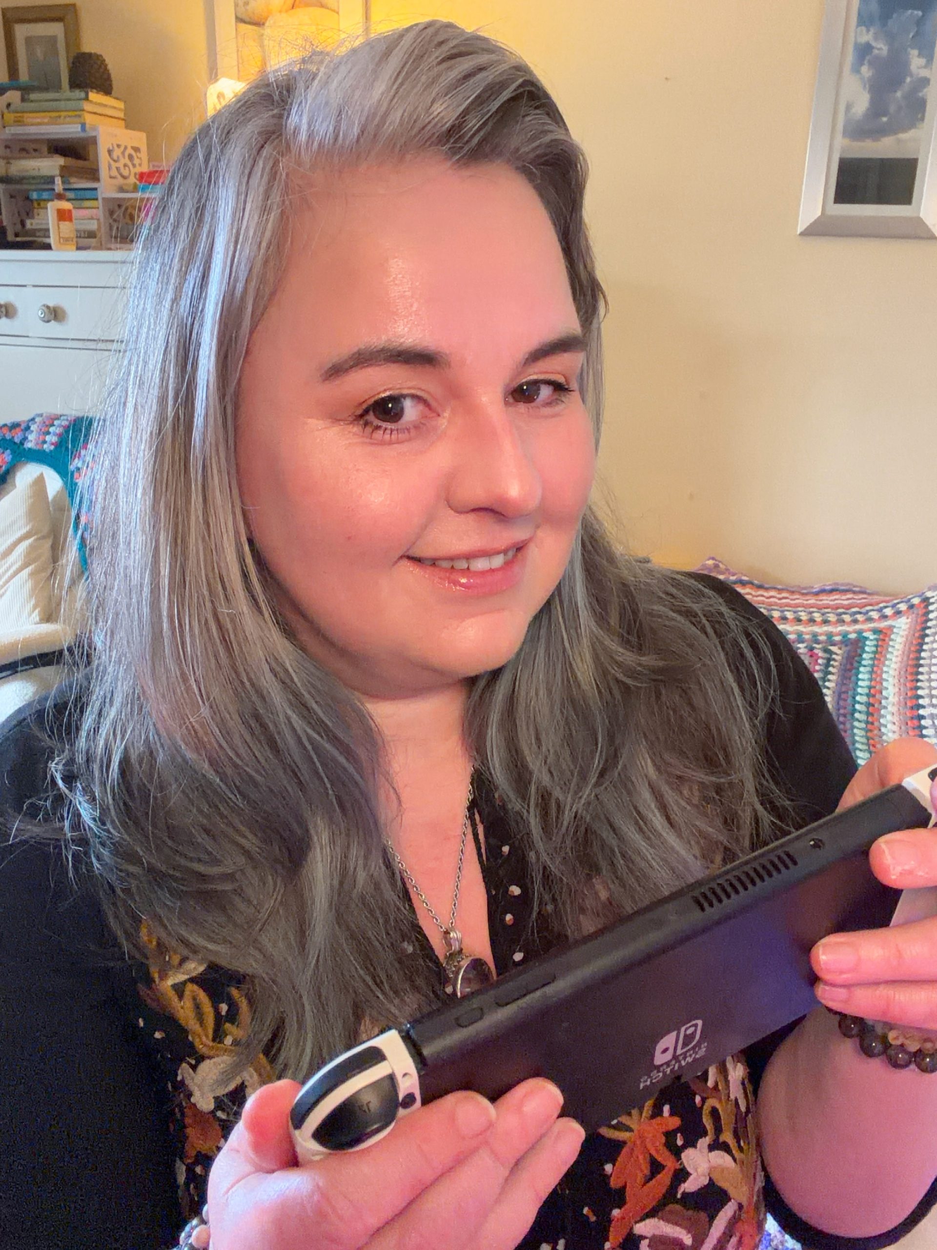 Gem, creator of Novachasing, smiling with a gaming controller